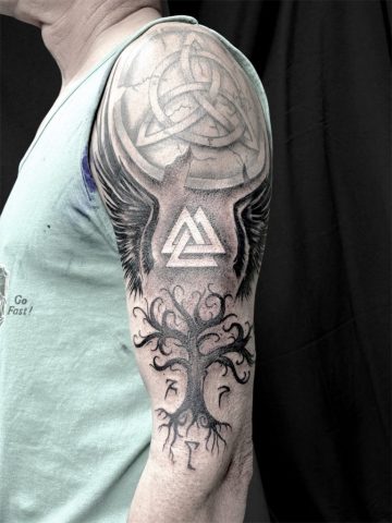 Nordisches Custom Tattoo mit Valknut Symbol, Lebensbaum und abstrakten Black & Grey Elementen, kraftvolles nordic Tattoo am Oberarm mit weichen Schattierungen und mystischer Symbolik, individuelles Viking Tattoo Design in modernem Blackwork Stil, handgezeichnetes Unikat von Sabine Jacobs im Talisman Tattoo Studio in Raeren – Premium Tattoo Studio für nordische Tattoos nahe Aachen, Eupen und Ostbelgien.